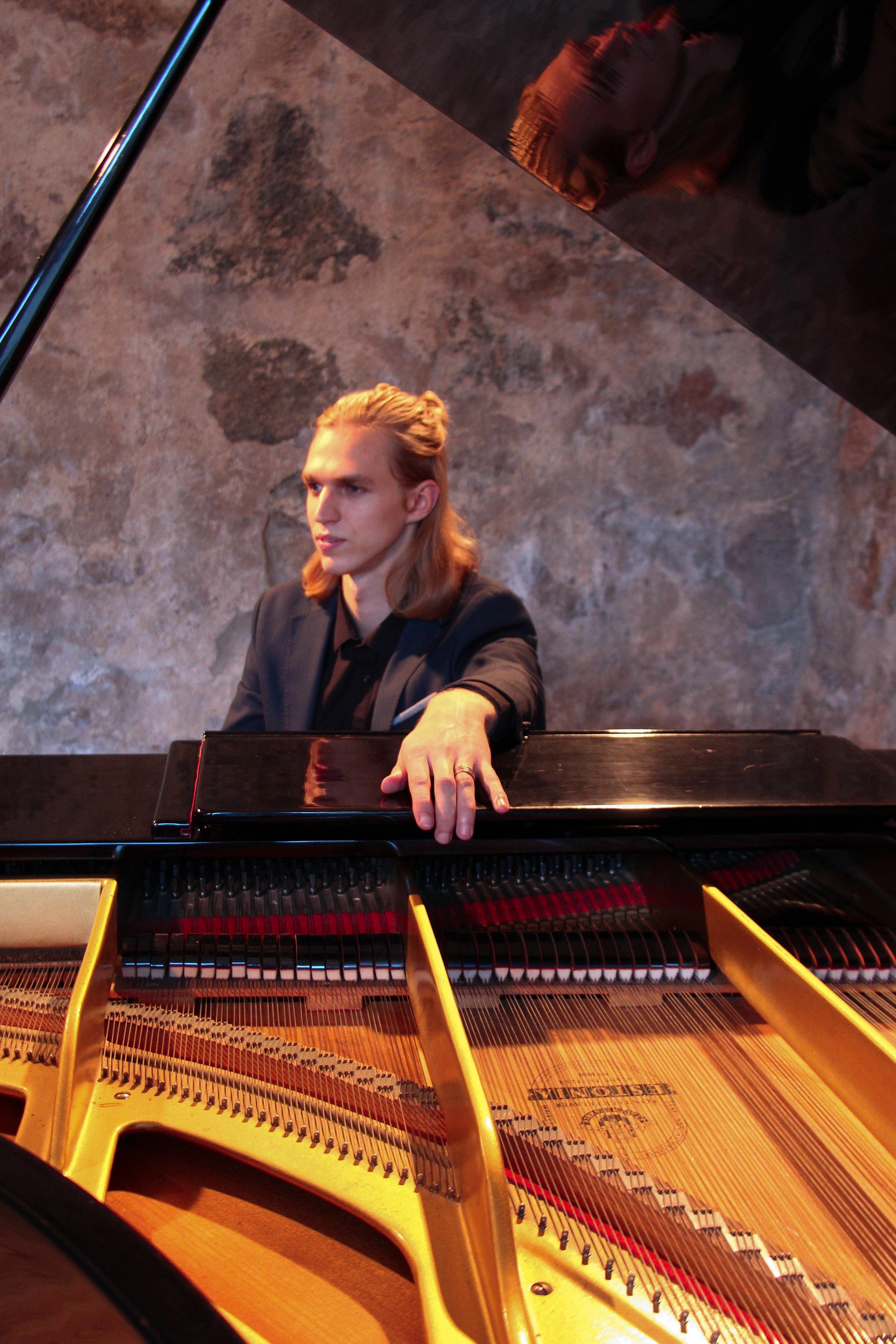 Portrait of Latvian composer and pianist Artūrs Rasa at the piano